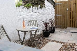 a table and chairs on a patio with ice formations at The Courtyard Apartment with parking in Ilfracombe