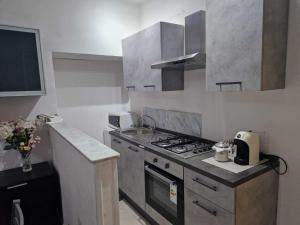 a kitchen with a stove and a sink in it at Casa Vancanza Happy Holidays in Pompeii in Pompei