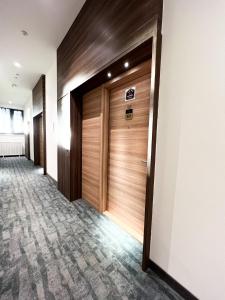 a hallway with wooden doors in a building at Woodside 007 in Kopaonik