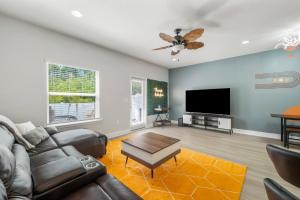 a living room with a couch and a flat screen tv at 7654 Shadow Lake Drive - Ocean's Eleven in Panama City Beach