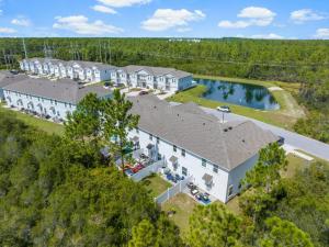 an overhead view of a large white building with a pool at 7654 Shadow Lake Drive - Ocean's Eleven in Panama City Beach