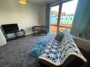 a living room with a bed and a large window at Modern apt next to Temple meads and Bristol Centre in Bristol