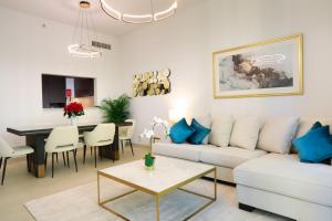 a living room with a couch and a table at Stunning Apartment with Direct access to Dubai Mall in Dubai
