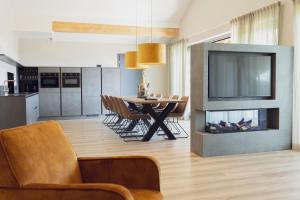a kitchen and dining room with a table and a fireplace at Weitblick Winterberg in Winterberg