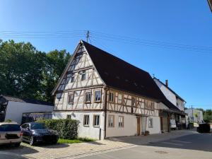 a building with a cross on the top of it at Ganze Wohnung - Erdgeschoss - sehr ruhig - Hundefreundlich - Regendusche - Bodenheizung - Küche - easy Check-in mit Schlüsselbox in Nehren