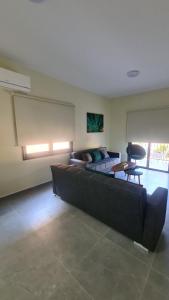 a large living room with a couch and a table at Central Two Bedroom Apartment, No 101, by IMH Travel & Tours in Paphos