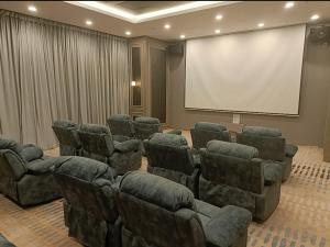 a conference room with chairs and a white screen at Sky Trees Nflix Make Up Table with Pool & Facilities in Johor Bahru