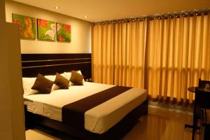 a bedroom with a large bed in a room at Hotel Puma'r Tacna in Tacna