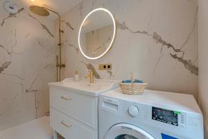 a bathroom with a washing machine and a sink at Orion in Trouville-sur-Mer +35 photos