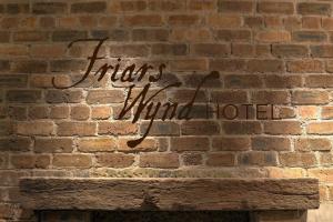 a brick wall with a sign that reads traitor third hotel at Friars Wynd Guest Rooms in Stirling