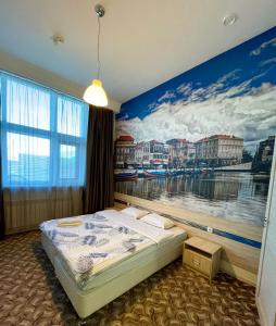 ein Schlafzimmer mit einem Wandbild eines Flusses in der Unterkunft Elysian hotel in Astana