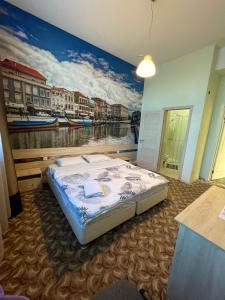 Schlafzimmer mit einem Bett mit Wandgemälde in der Unterkunft Elysian hotel in Astana