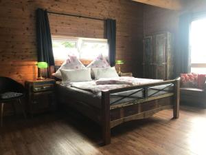 a bedroom with a bed with pillows and a window at Obere-Seeterrasse in Rieden