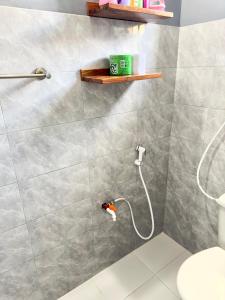 a bathroom with a shower with a toilet at Sally's home-near JNIA airport in Dar es Salaam