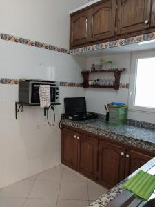 a kitchen with a counter top with a microwave at Maison traditionnelle marocaine in Rabat