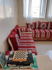 a living room with a couch with a chessboard on a table at Maison traditionnelle marocaine in Rabat