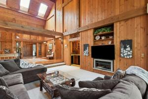 a living room with wood paneled walls and a television at Galena Getaway with Hot Tub, Home Theater and More! in Galena