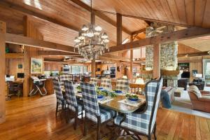 a dining room and living room with a table and chairs at Galena Getaway with Hot Tub, Home Theater and More! in Galena