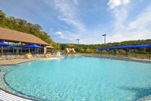una grande piscina in un resort con ombrelloni blu di Galena Getaway with Hot Tub, Home Theater and More! a Galena