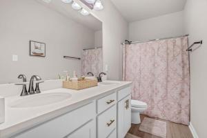 a bathroom with a sink and a toilet and a shower at Oasis of Relaxation next to LSU perfect for groups in Baton Rouge +8 photos