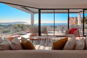 a living room with a couch and a view of the ocean at Prestigious villa with panoramic sea view in Bandol
