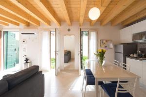 a kitchen and living room with a table and a couch at Ca' Martina in Venice