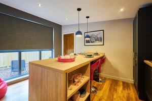 a kitchen with a wooden island in a room at Host & Stay - Ocean Blue Lodge in Alnwick