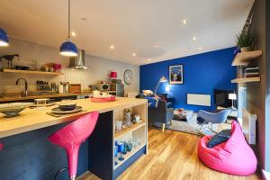 a kitchen and living room with pink stools at Host & Stay - Ocean Blue Lodge in Alnwick