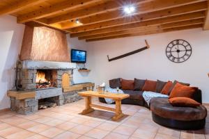 a living room with a couch and a fireplace at Gîte La Grange logement de qualité in Cauterets