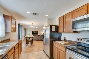 a kitchen with wooden cabinets and a counter top at Sunny Universal City Home about 18 Mi to San Antonio! in San Antonio