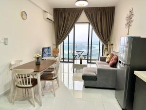 a kitchen and living room with a table and a refrigerator at Golden Tree @ Country Garden Danga Bay in Johor Bahru