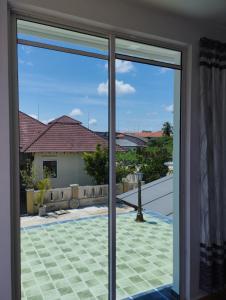 Habitación con puertas correderas de cristal que dan a un patio. en Inap Idaman 7 5 Pax 2 Queen Plus 1 Sofa Bed, en Kota Bharu
