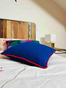 a blue pillow sitting on top of a bed at La vue lac in Les Grangettes