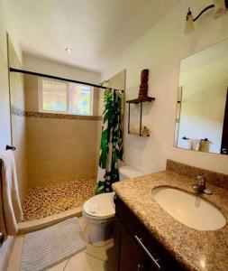 a bathroom with a sink and a toilet and a shower at Cabo Velas 19 Jungle Paradise in Santa Cruz