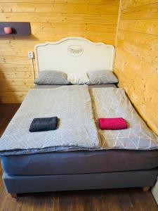 a bed in a room with two pillows on it at Chatky Daniel-Mikulov, a private campsite just for you in Mikulov
