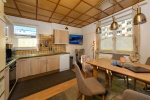 a kitchen with a table and a dining room at Landhaus Josefa in Flachau