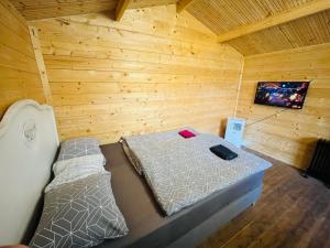 a room with a bed in a wooden cabin at Chatky Daniel-Mikulov, a private campsite just for you in Mikulov