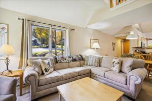 a living room with a couch and a table at Woods V17 2-Bed & Loft with Fireplace, whirlpool tub, and sports center in Killington +42 photos