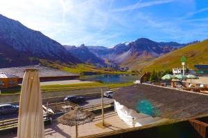 a resort with a view of a lake and mountains at Tignes Le Lac - Appartement au pied des pistes (6 personnes) in Tignes