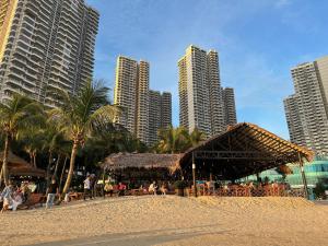 a restaurant on a beach with tall buildings at Golden Tree @ Country Garden Danga Bay in Johor Bahru