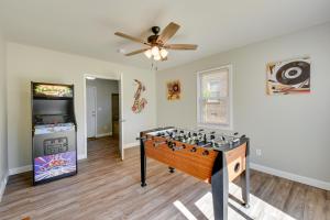 a living room with a foosball game in the center at Greenville Vacation Rental - 3 Mi to Downtown! in Greenville