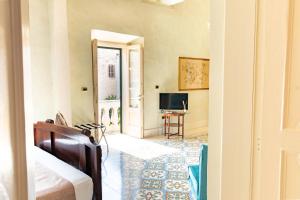 a living room with a television and a door at Palazzo Zacà in Gallipoli