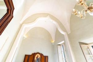 a hallway of a house with a chandelier at Palazzo Zacà in Gallipoli