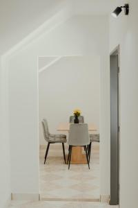 a dining room with a table and a chair at Apartmán EMILY in Brezno
