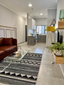 a living room with a couch and a table at Sarona LoLa E206 in Gaborone