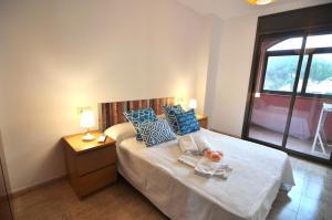 エンプリアブラバにあるRNET - BCel Empuriabravaのベッドルーム1室(青い枕のベッド1台、窓付)