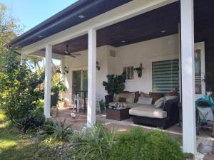 a screened in porch of a house with a couch at Naples' Hidden Gem in Naples