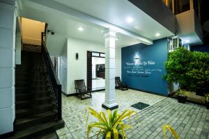 a lobby with a staircase and a blue wall at Sea Yo Villa - Hikkaduwa in Hikkaduwa