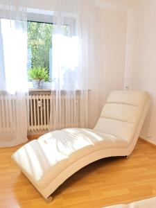a white bed in a room with a window at Art & Living House in Schoneck