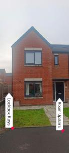 a red brick house with signs in front of it at H8 Room 3 Serene Home with 15 min walk to City Centre, Free car parking,Late Night Check In Anytime, 2 min walk to Bus Stop in Manchester